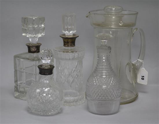 A large lemonade jug, three silver mounted decanters and another